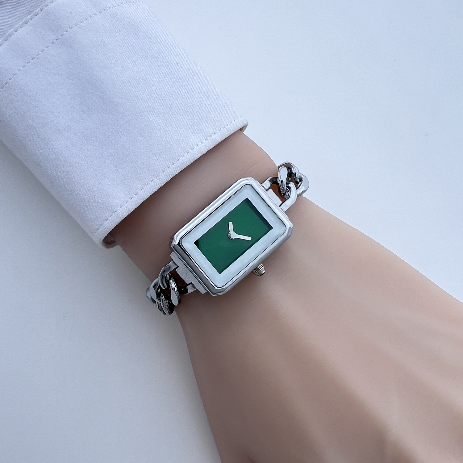 Silver shell, white edge glass, green surface (separate watch)
