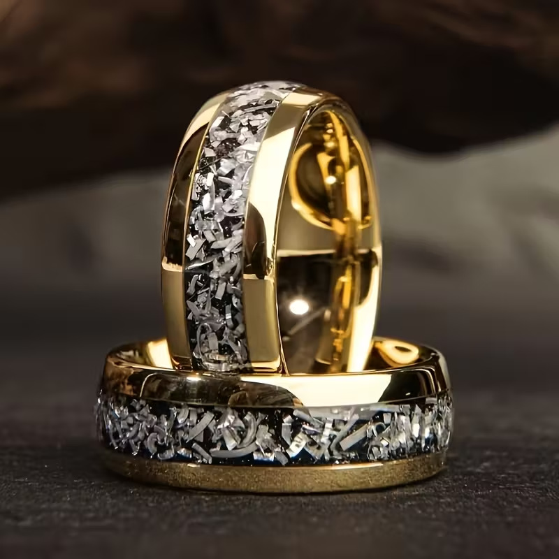 Gold-plated stainless steel ring with black background and silver accents